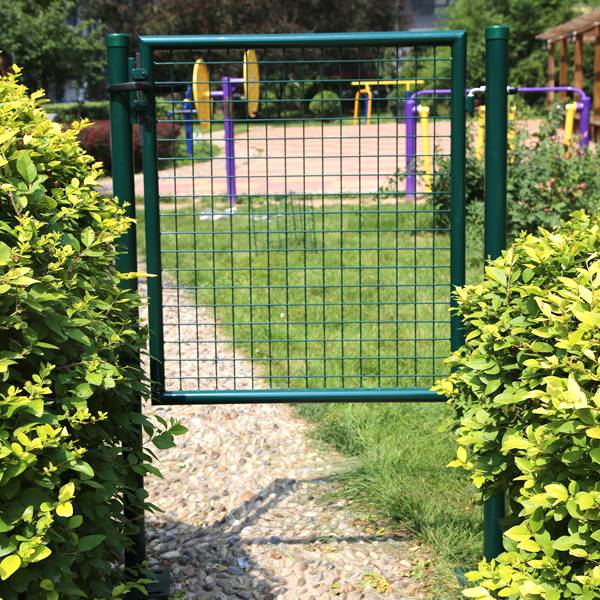 Green garden gate installed at the entrance to the garden.